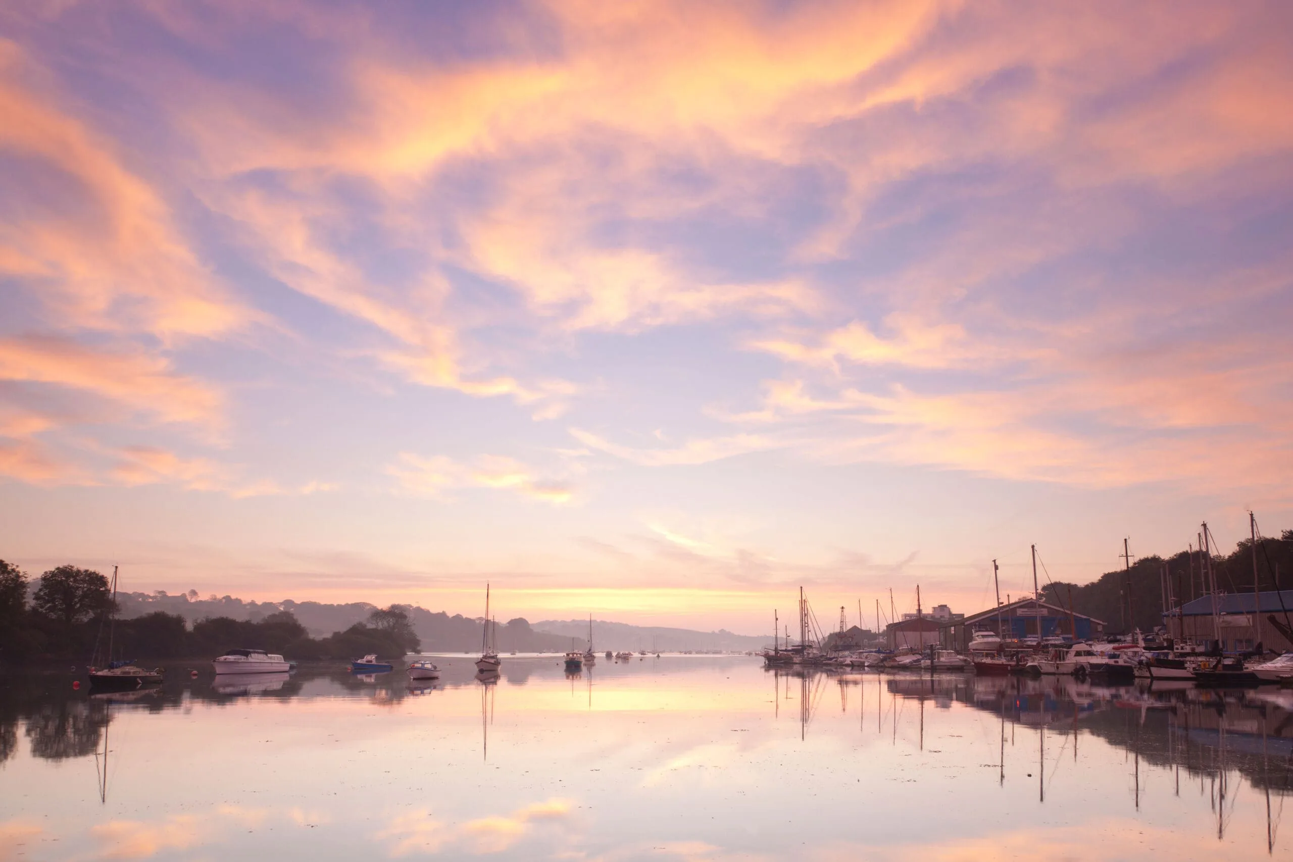 A beautiful dawn sky over the tidal river at Penryn, Cornwall